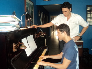 Artur Rodrigues (at the piano) and José Caminha in their house in Rio de Janeiro.  Credit: Fabiana Frayssinet /IPS