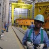 Zenaide Pereira da Silva in front of the gantry crane she operates.  Credit: Mario Osava/IPS 