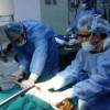 Sameh Saeed (left) performs a surgical procedure on a 23-year-old Libyan with a broken hand and vascular injury in Ajdabiya Hospital on Apr. 10. Credit: Sameh Saeed