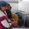 Claudia Consamollo, 16, washes the clothes of the youngest members of the community with recycled soap.  Credit: Milagros Salazar/IPS