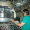 Worker and textile machine at an Ametex factory.  Credit: Bernarda Claure