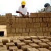 Nidal Eid builds his home with mud bricks Credit: Eva Bartlett