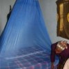 A member of Kindlimuka arranging her insecticide-treated bed net. Credit: Ruth Ayisi