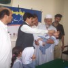 Swat official administers polio drops. Credit: /IPS