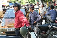 Xe Om (motorbike taxi) drivers await custom in Hanoi.  Credit: Matt Bennett/IPS