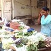 A door-to-door vegetable vendor uses her mobile phone to increase her earnings.  Credit: Ranjit Devraj 