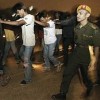 Migrant workers being marched off to detention centre  Credit: Baradan Kuppusamy/IPS
