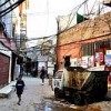 A young boy walks past a U.N. vehicle in Bourj al-Barajneh camp. Credit: UN Photo