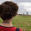 Anna Keenan, one of the hunger strikers, has a tattoo on her neck that reads "climate justice".  Credit: Robert van Woorden