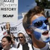 Demonstrators, one with a Scottish flag painted on his face, taking part in the Make Poverty History march through the centre of Edinburgh. Credit: Aubrey Wade  / panos pictures