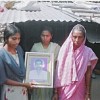 Survivors holding up picture of Shridhar Uttam Bhyute, a farmer who committed suicide.  Credit: Bharat Dogra/IPS