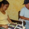 Rosmery González's parents look at photos of their murdered daughter.  Credit: Danilo Valladares/IPS