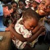 UNICEF Goodwill Ambassador Roger Moore assists with polio immunisation in Elmina, Cape Coast, Ghana. Credit: UNICEF