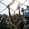 MINUSTAH soldiers provide security at a crowded stadium in the coastal city of Léogâne where food is being distributed. Credit: UN PHOTO/Sophia Paris 