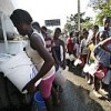 Haitians displaced by the powerful earthquake receive water out of a truck in the Canapé-Vert area of Haiti capital Port-au-Prince.  Credit: UN Photo/Sophia Paris