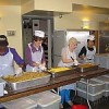 Volunteers help prepare a meal at the Holy Apostles Soup Kitchen. Credit: Heike Barkawitz/IPS