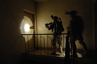 Two U.S. Army soldiers search a building for weapons caches in Baghdad on Apr. 16, 2008. Credit: US Defence Dept/Spc. Lester Colley