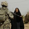 U.S. Army Spc. Trevor Aguon speaks with a local woman during a mission in Ar Raqqah, Iraq, Jul. 6, 2007.  Credit: U.S. Air Force photo by Senior Airman Steve Czyz
