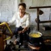 Kommaly Chantavong reels silk. This is still done using utensils and methods that are hundreds of years old  Credit: Melody Kemp/IPS