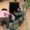 PLA soldiers Sujata (left) and Kabita with baby. Bindu (right) was pregnant when her Maoist husband was killed. She lost the baby because of unsafe delivery practices. Credit: Mukunda Bogati/IPS