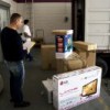 David Villavicencio packs boxes for his trip home to Ecuador.  Credit: Benedict Moran/IPS