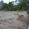 A young man watches the raging waters after Hurricane Noel&#39s passage across the Dominican Republic. Credit: Instituto Nacional de Recursos Hidraulicos