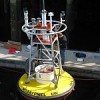 U.S. scientists make final adjustments to the first buoy measuring ocean acidification. It was deployed Jun. 7 in the Gulf of Alaska. Credit: NOAA