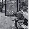 Resident of the working-class Downtown Eastside neighbourhood in Vancouver sits at a bus shelter. Credit: Elaine Briere/IOCC