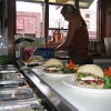 A customer waits for her food at the organic Roots restaurant. Credit: Enrique Gili