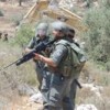 Israeli soldiers confronting anti-separation barrier protestors on the West Bank. Credit: Willow Heske