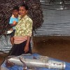 A woman with an unexploded shell that landed in her home in Vakari village, Batticaloa  Credit: Sanjaya Nallaperuma/IPS 