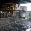 Slum homes built under a highway overpass in Jakarta, Indonesia. Credit: Jonathan McIntosh