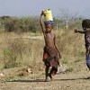 Children of the Ambororo nomadic tribe in south Darfur carry water in plastic containers for their families. Credit: UN Photo/Tim McKulka 