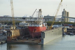 Deep sea drilling vessel undergoing repairs in a floating drydock at the port of Tampa, USA. Credit: Trevor Page