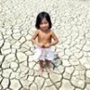A Brazilian girl stands in a dry riverbed in Manaquiri, in Amazonas state - Ricardo Oliveira.