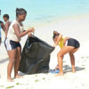 Cuban girls cleaning up a beach. - Julio Haedo