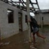 In Pinar del Río, a woman returns to her house, which was damaged by Hurricane Ike. - Jorge Luis Baños/IPS