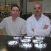Jadson Belchior, left, and Geraldo Magela Lima and their tiny, carbon-absorbing ceramic spheres. - Courtesy of UFMG/Diogo Domingues