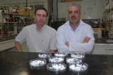 Jadson Belchior, left, and Geraldo Magela Lima and their tiny, carbon-absorbing ceramic spheres. - Courtesy of UFMG/Diogo Domingues Jadson Belchior, left, and Geraldo Magela Lima and their tiny, carbon-absorbing ceramic spheres. - Courtesy of UFMG/Diogo Domingues