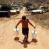 Carrying water in the Chico Mendes landless peasant settlement in Pernambuco, Brazil. - Alejandro Arigón/IPS.