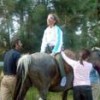 Dr. Nieves guides an equine therapy patient - 